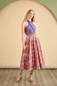The Bellamy Dress is a criss cross halter dress with a full skirt and a clean side seam zipper.