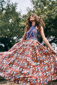 The Bellamy Dress is a criss cross halter dress with a full skirt and a clean side seam zipper.