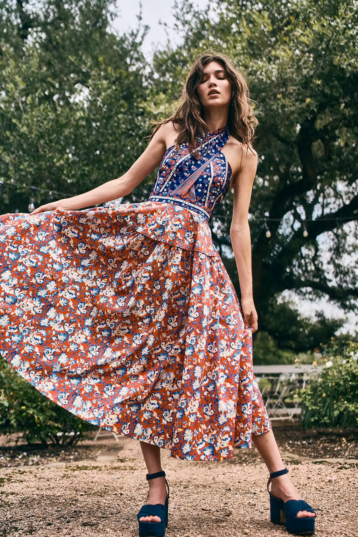 The Bellamy Dress is a criss cross halter dress with a full skirt and a clean side seam zipper.