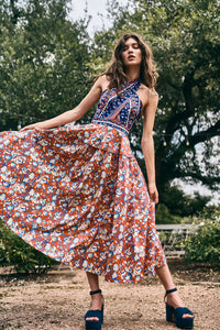 The Bellamy Dress is a criss cross halter dress with a full skirt and a clean side seam zipper.