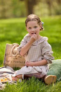 Little English traditional children's clothing.  Long sleeve blouse in tan and blue Durham Windowpane with a ruffled collar paired with matching skirt with blue smocked waistband for girls