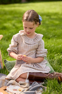 Little English traditional children's clothing.  Long sleeve blouse in tan and blue Durham Windowpane with a ruffled collar paired with matching skirt with blue smocked waistband for girls