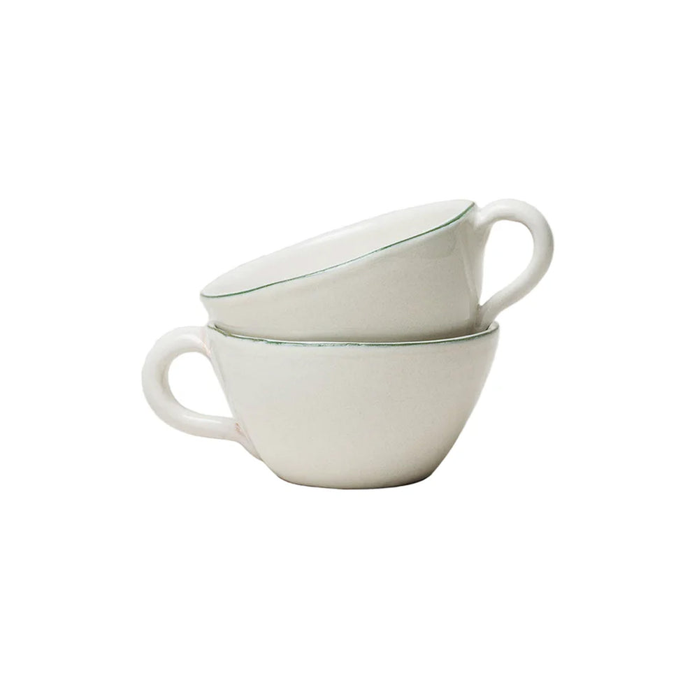 Angled view of stacked Bevagna latte cups in glazed terracotta with thin green rim on white