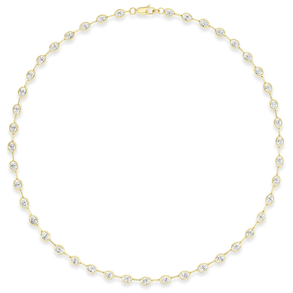 The Bezel Set Oval Diamond Necklace in Yellow Gold features evenly spaced oval diamonds, each set in a bezel of 18k yellow gold, arranged in a circle against a white background.
