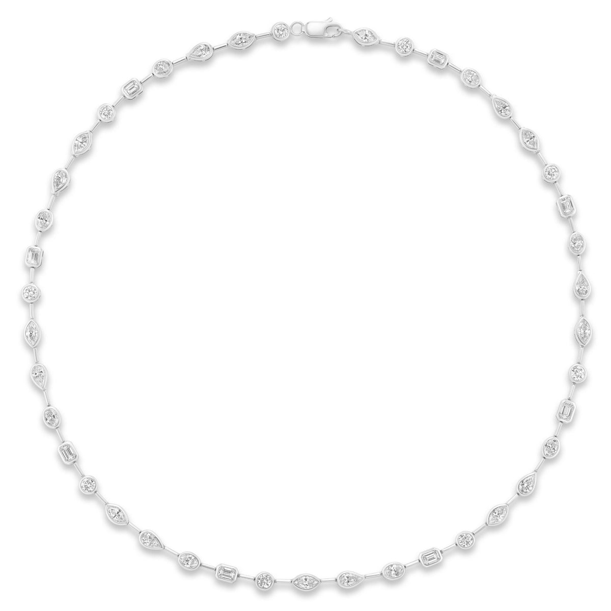 The Bezel Set Mixed Shape Diamond Necklace in white gold features oval, round, and rectangular diamonds set along a delicate chain, shown arranged in a circle on a white background.