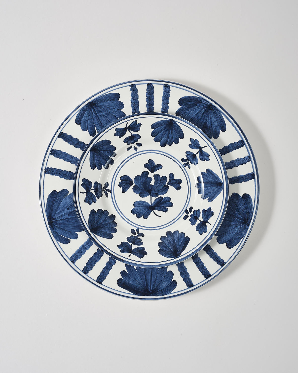 Top view of Blossom Dessert Plate, Midnight Blue showcasing hand-painted deep blue floral motifs on a white background