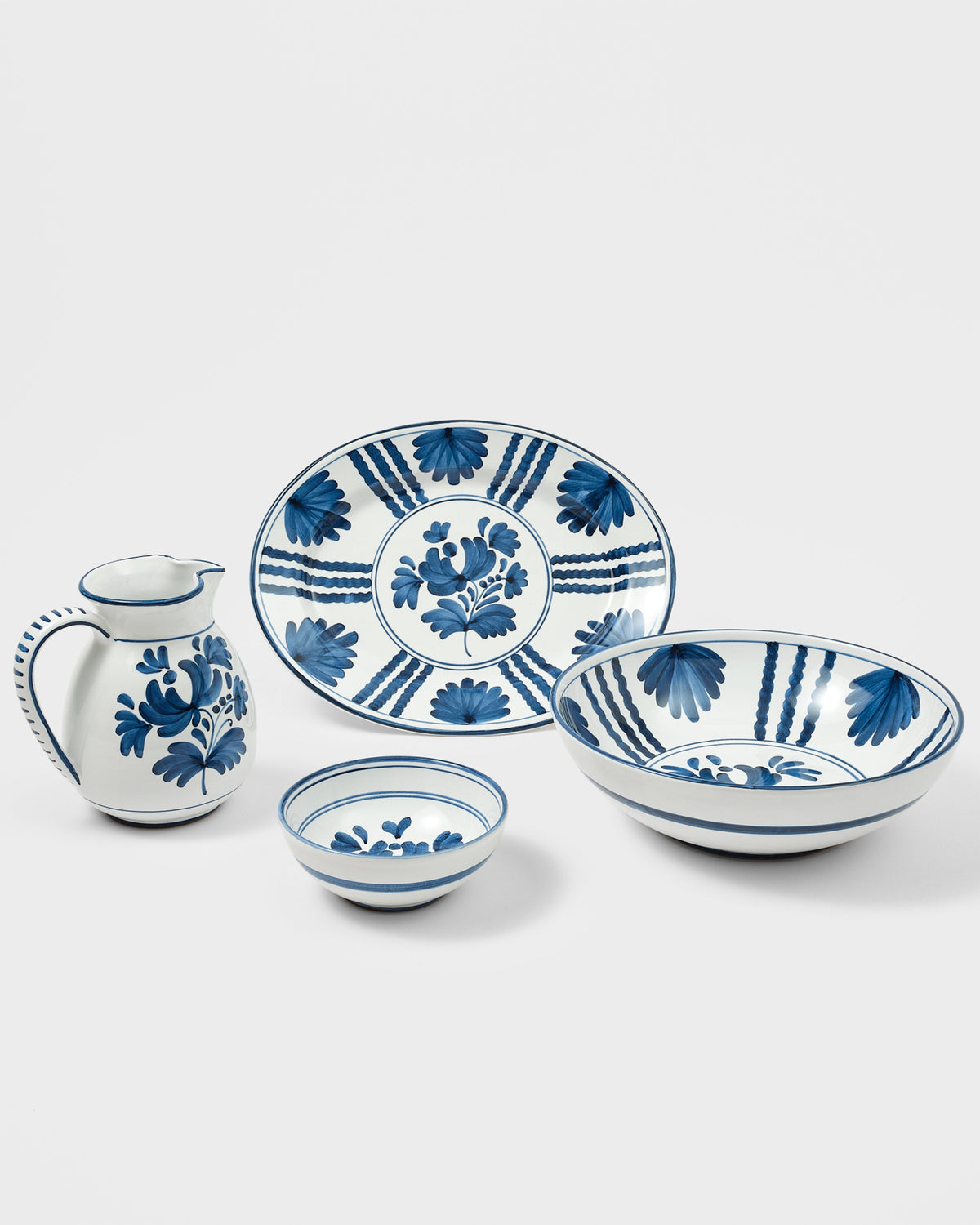 Angled view of Blossom Oval Serving Plate, Midnight Blue showcasing hand painted floral motifs on a light gray background