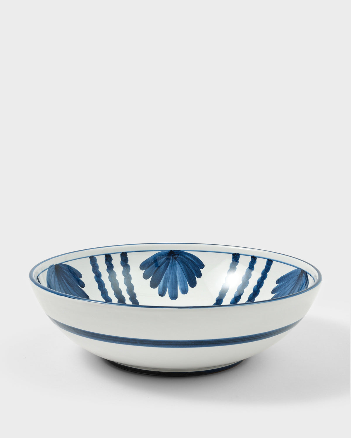 Close view of Blossom Salad Bowl, Midnight Blue showcasing blue floral motifs on white ceramic