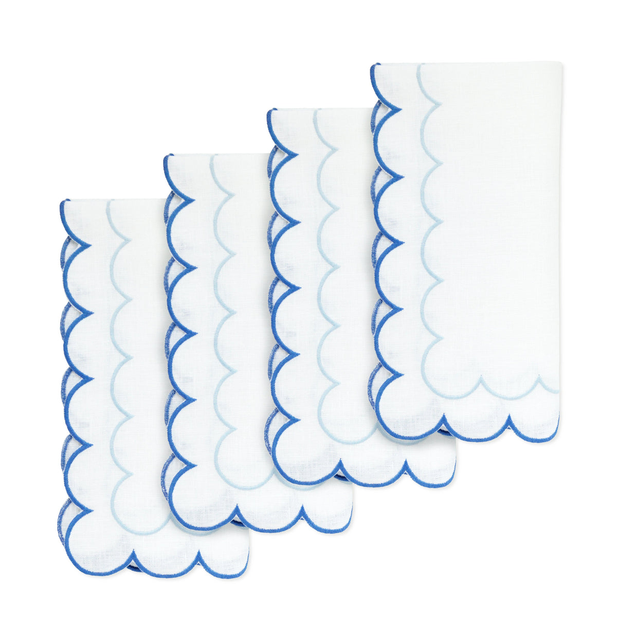 Close-up of Blue Scalloped Dinner Napkins, Set of 4 showcasing blue scalloped edges on white linen against a white background