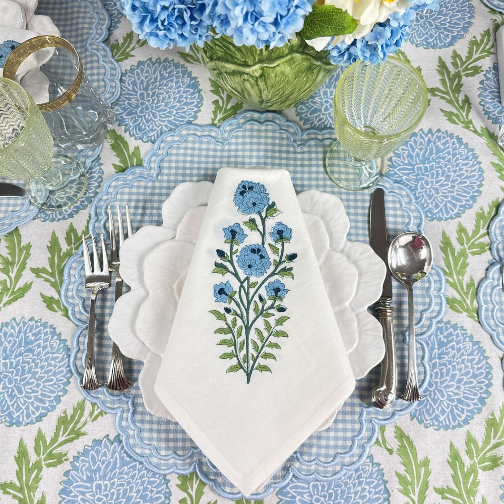 Blue motif napkin on blue gingham placemat on blue flower tablecloth
