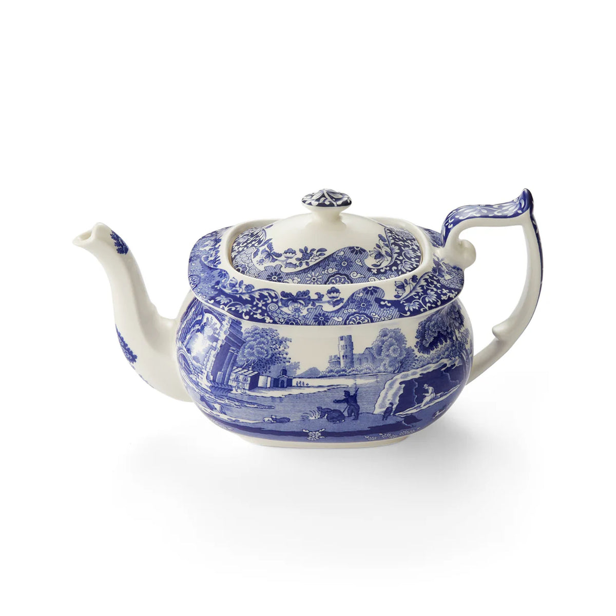 Front view of Blue Italian teapot showing Spode blue-and-white countryside pattern, lid and handle on white background