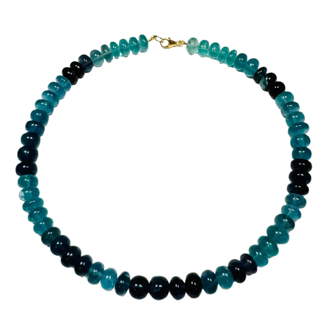 Top-down view of Blue Lagoon Candy Necklace showcasing graduated blue-green fluorite rondelle beads and 14K gold-filled lobster clasp on white background