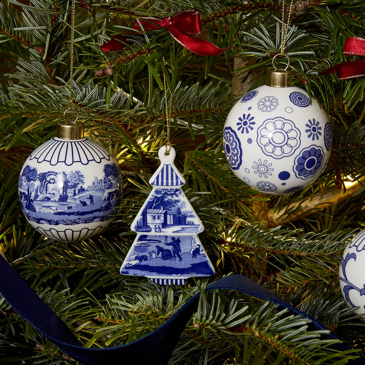 Front view of Blue Italian Christmas Bauble with Full Scene showcasing its blue and white scenic motif on a Christmas tree