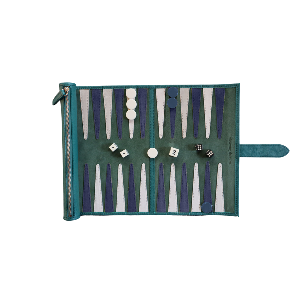 Top-down view of Travel Belfast Backgammon Board showcasing green suede playing field, blue and white points, leather zip strap and playing pieces