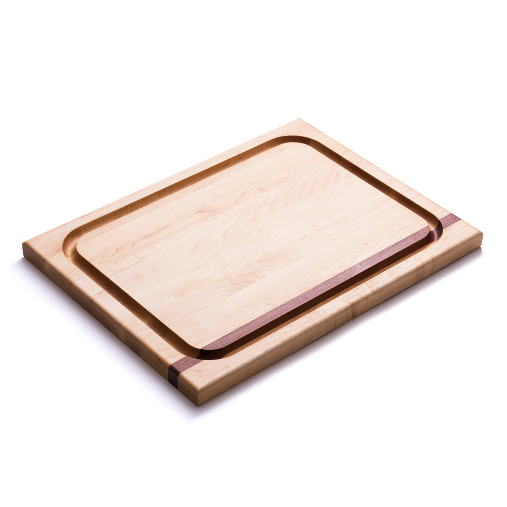 Angled top-down view of Carving Board showcasing maple surface, mahogany inlay and carved juice groove on white background