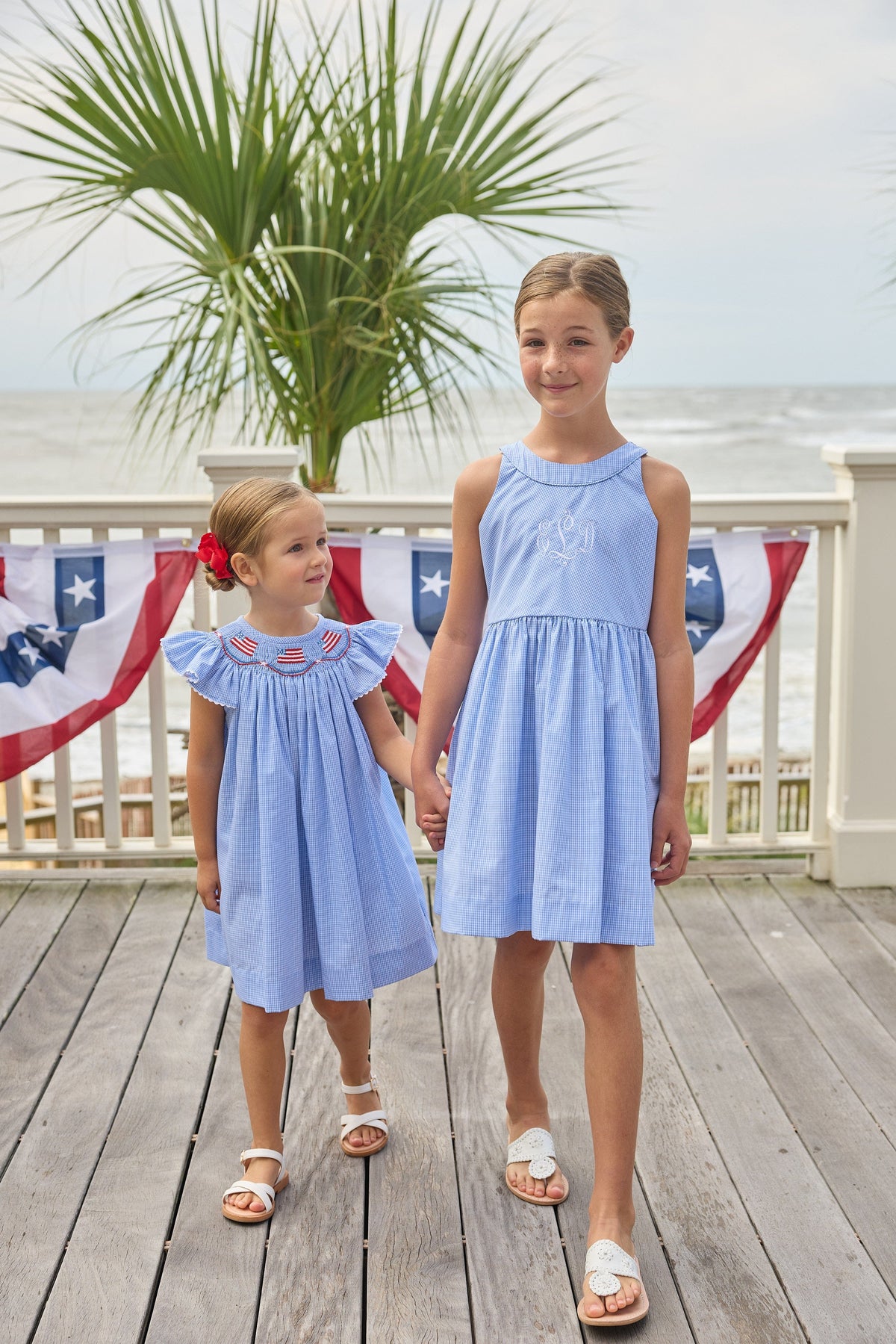 Little English traditional children's clothing.  Royal blue mini gingham sleeveless dress with white ricrac trim and bow tie in back for little girls