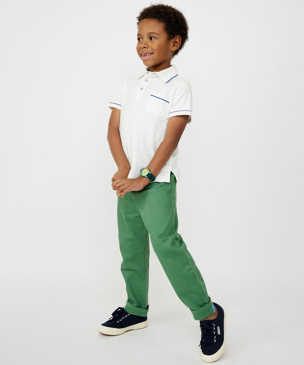 Three-quarter view of Bowie pant in green on child model showing cuffed hem and straight fit against white background