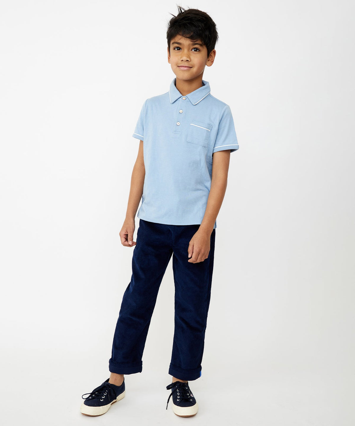 Full-length front view of Bowie Pant in navy corduroy on child model showing cuffable contrast hem and pull-on fit against white background