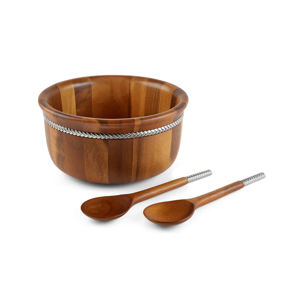 Front view of round acacia wood salad bowl with chrome-braided rim and two matching servers on white background