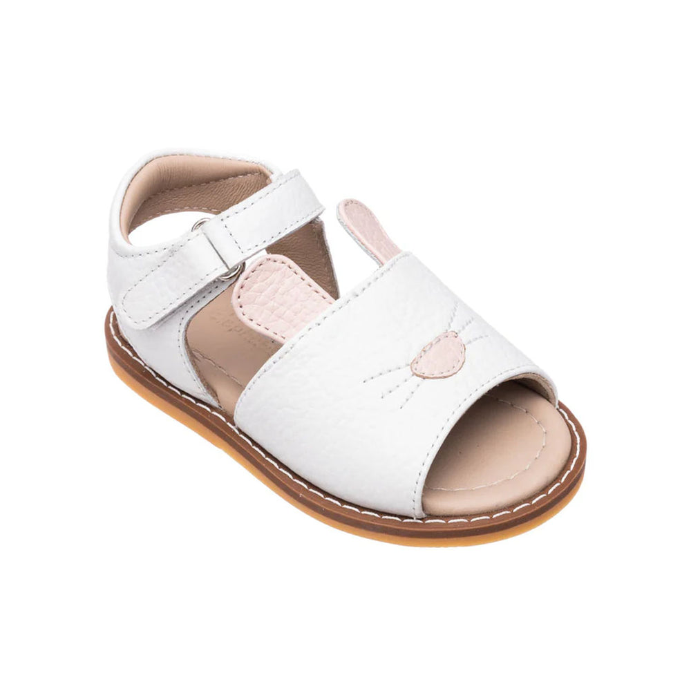 Angled view of white toddler sandal with embroidered bunny face and pink ears, adjustable ankle strap, open toe and tan sole