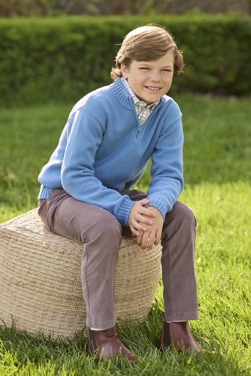 Little English traditional children's clothing. Stormy blue quarter zip sweater layered over blue, pink, and brown Wilmington Plaid button down shirt and paired with chocolate brown corduroy classic pants.  Fall outfit for boys