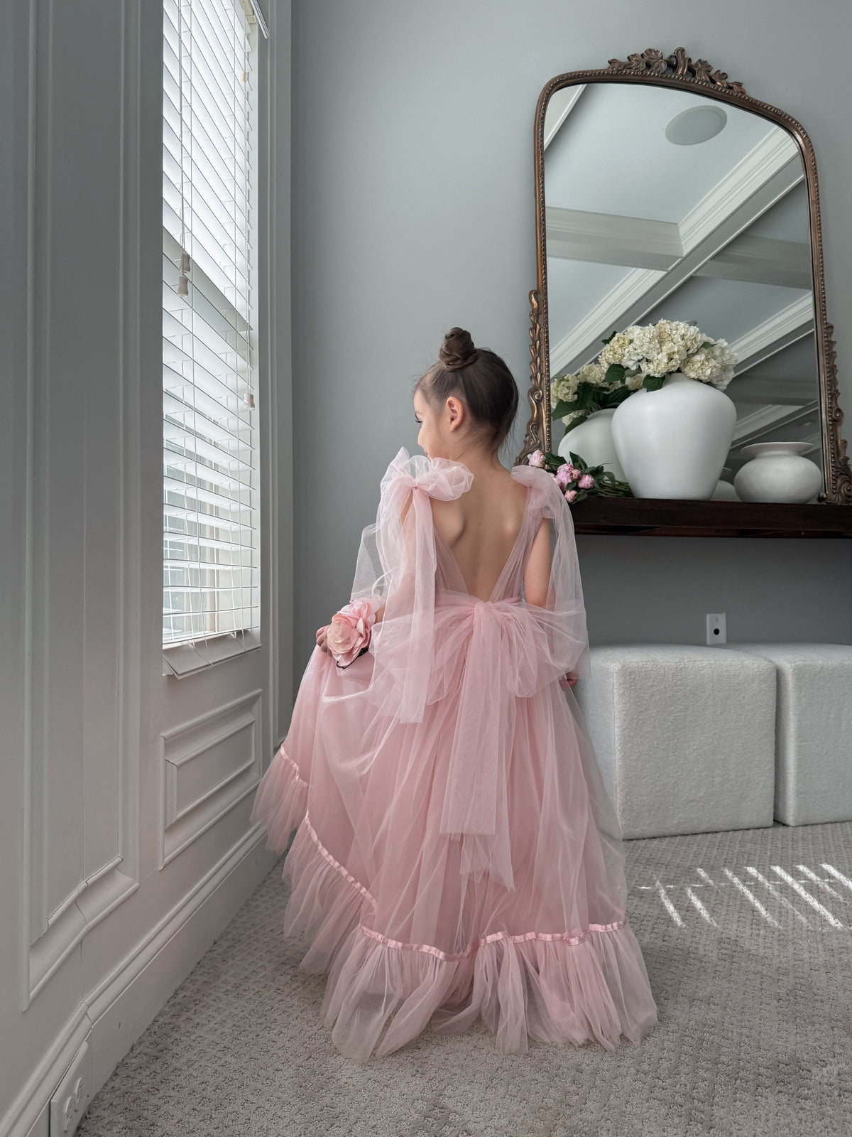 Back view of Camila Light Pink Tulle Gown showing deep V-back and oversized satin bow.