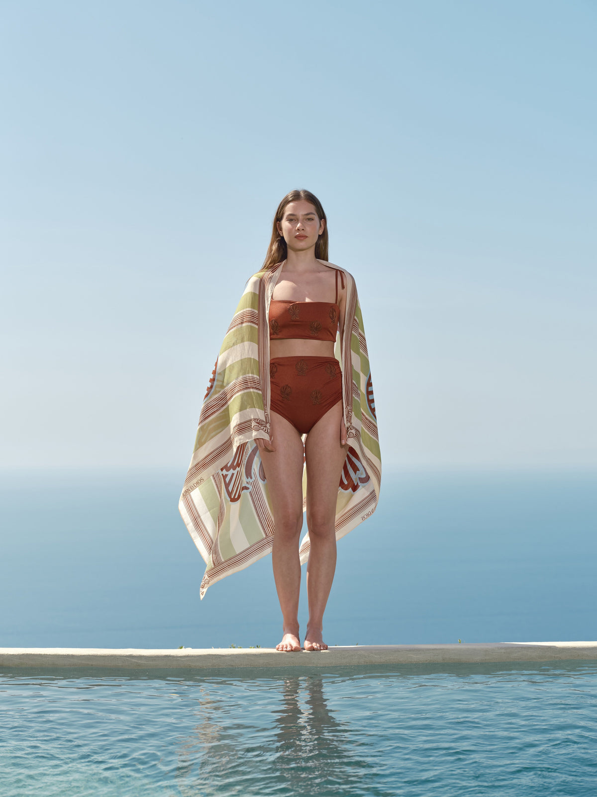 Front view of the San Miguel Bikini Top in Dattero & Namibia showcasing embroidery with a poolside background