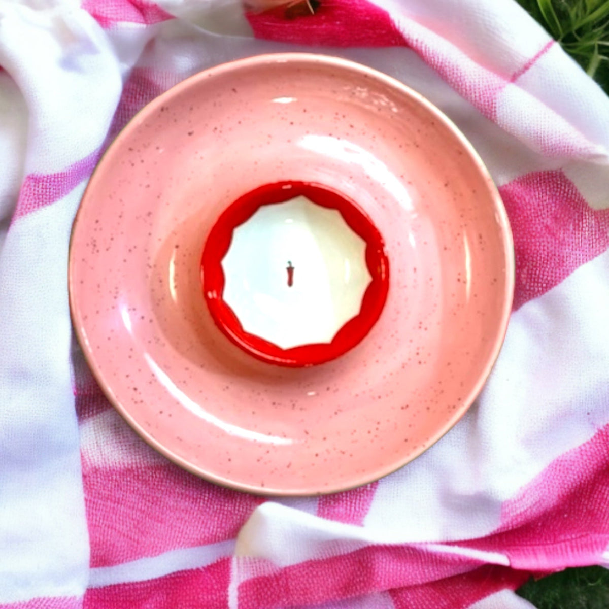 Top-down of Hand-painted Picante Platter showcasing pink speckled glaze and red scalloped center bowl on pink-and-white cloth