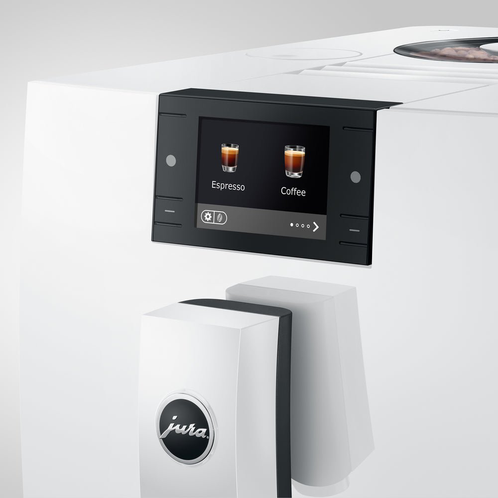Front close-up of C9 coffee machine in piano white showcasing touchscreen labeled Espresso and Coffee and front milk spout