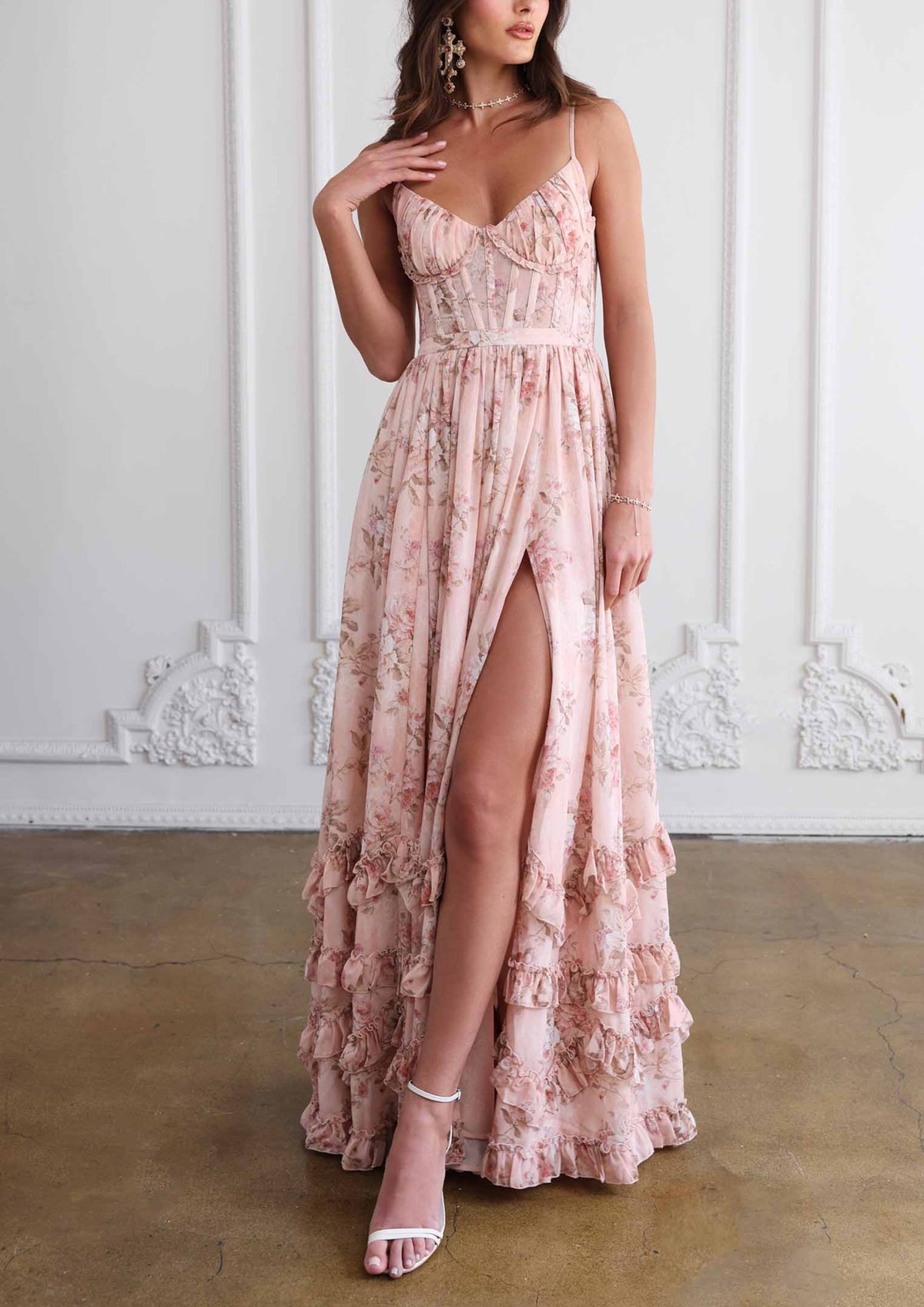Front view of The Carmen Dress in Peach Tapestry showcasing its floral corset bodice, side slit, and ruffled hem on a model
