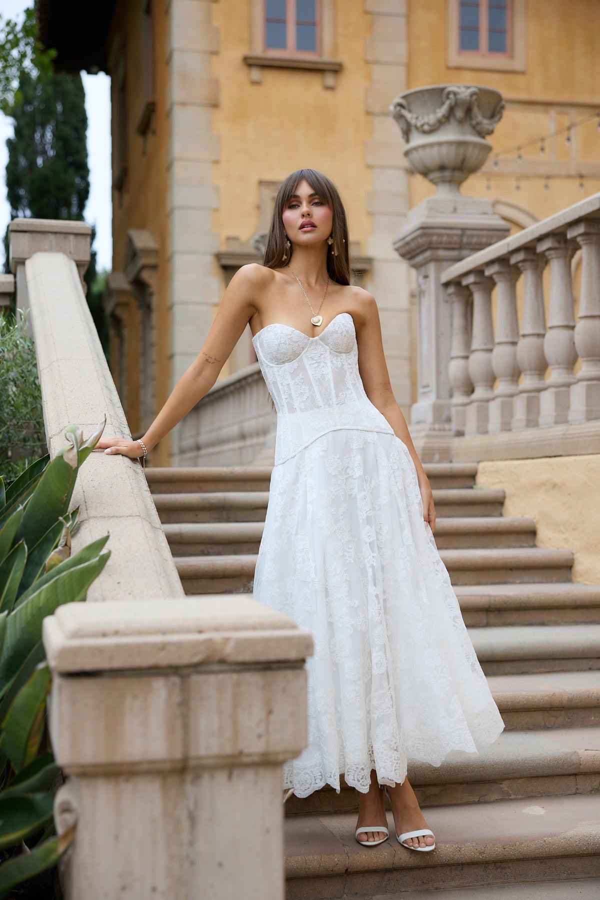 Front view of The Carolena Set in White Chantilly Lace showcasing hand-corded paisley lace and A-line skirt outdoors