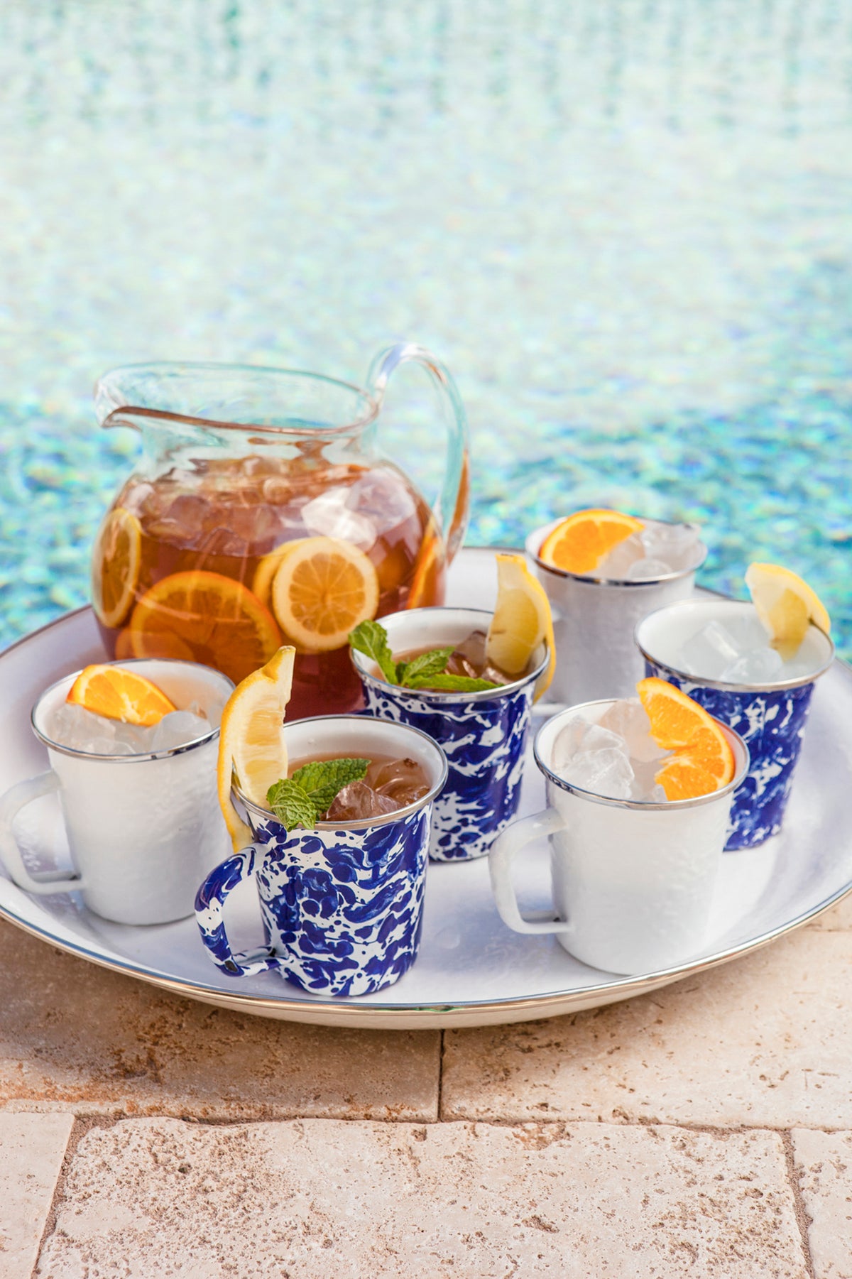 Cobalt swirl mugs arranged with citrus drinks on a serving tray