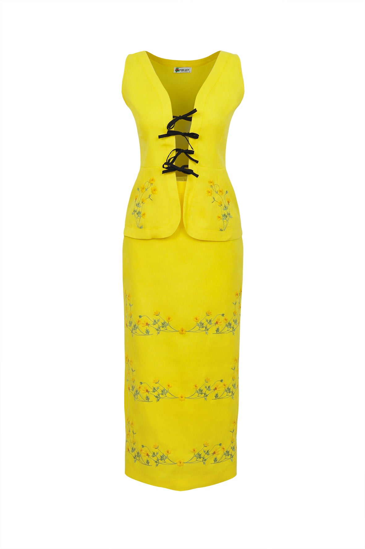 Front view of Cenan Skirt Set with bright yellow tie-front sleeveless top and embroidered pencil skirt on white