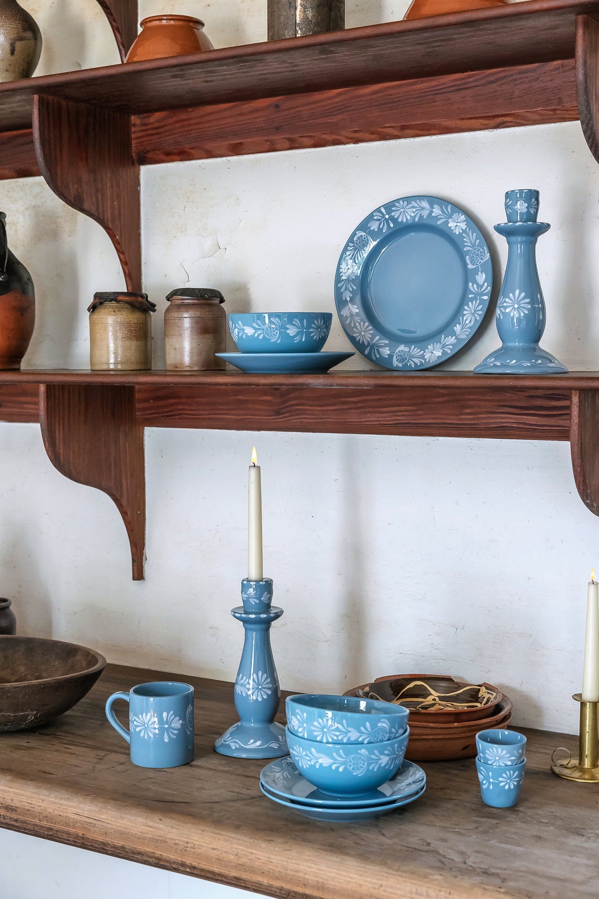 Blue Wythe espresso cup set arranged with blue ceramics on wooden shelves