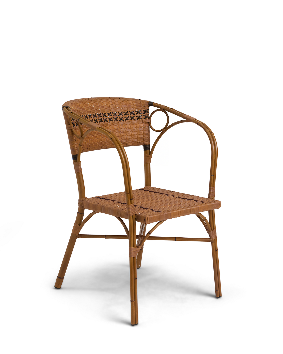 Three-quarter view of Juliette armchair with woven synthetic rattan seat and circular arm detail in hickory brown on white