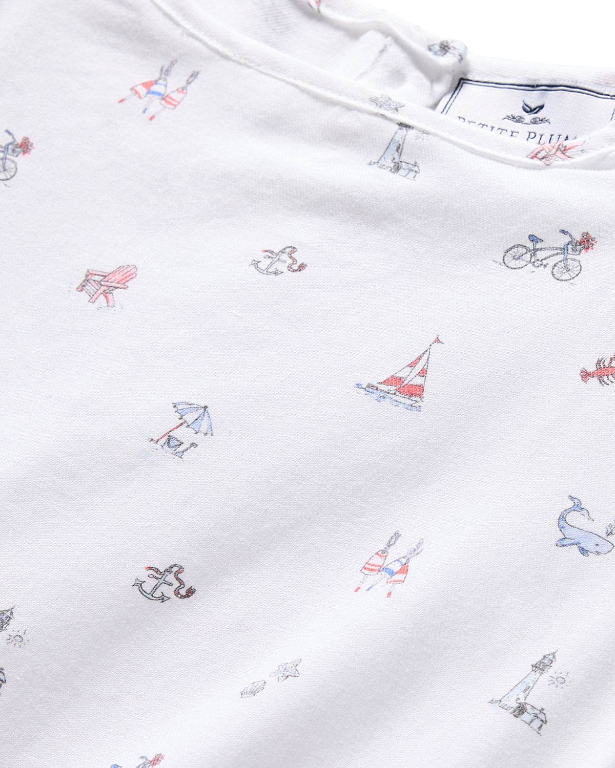 The Girls Twill Amelie Nightgown by Petite Plume in Coastal Charms features a white lightweight cotton fabric with small nautical prints like sailboats, bikes, lighthouses, anchors, whales, and deck chairs—blending comfort and style.