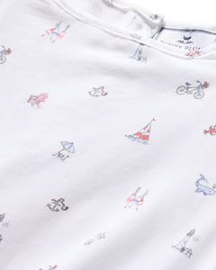 The Girls Twill Amelie Nightgown by Petite Plume in Coastal Charms features a white lightweight cotton fabric with small nautical prints like sailboats, bikes, lighthouses, anchors, whales, and deck chairs—blending comfort and style.