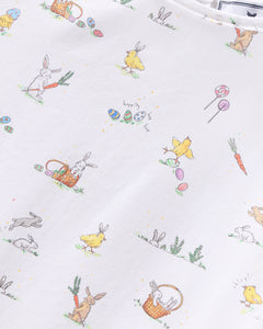 Petite Plumes Girls Twill Amelie Nightgown in Easter Frolic showcases whimsical rabbits, chicks, carrots, and colorful eggs on a white background, making it luxurious sleepwear for festive celebrations.