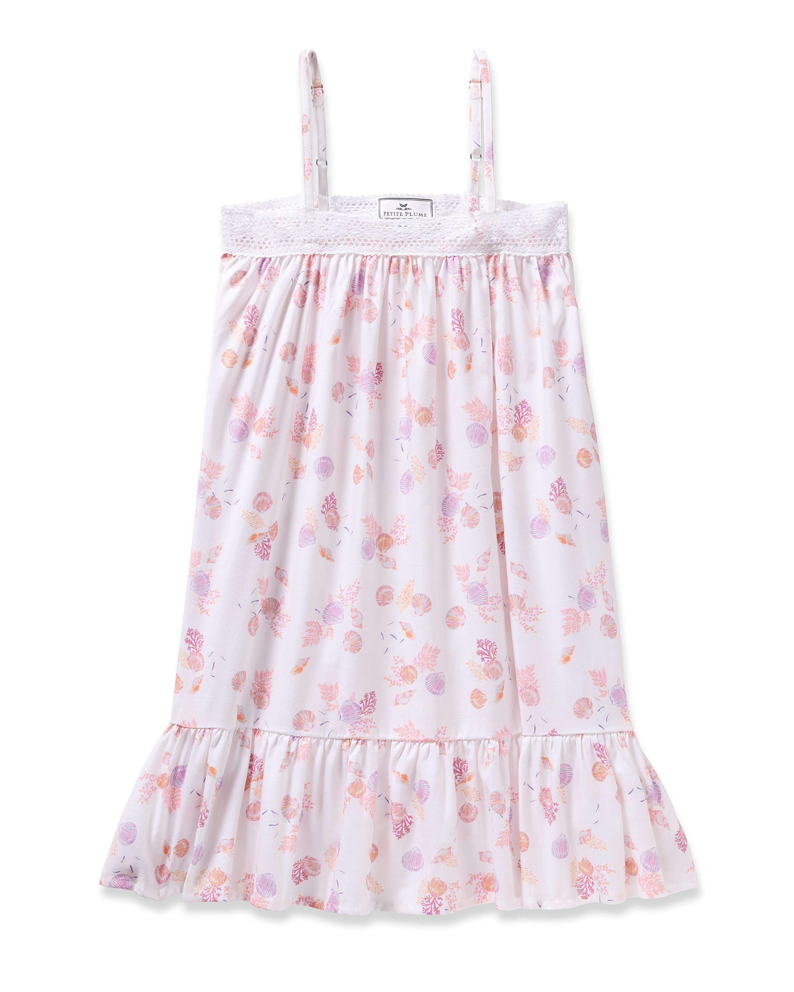 Enjoy the elegance of Petite Plumes Girls Twill Lily Nightgown in Seashell Splendor—a white sleeveless dress boasting pink and purple floral and fruit patterns, yarn-dyed cotton, a lacy trim top, and a ruffled hem for luxurious sleep.