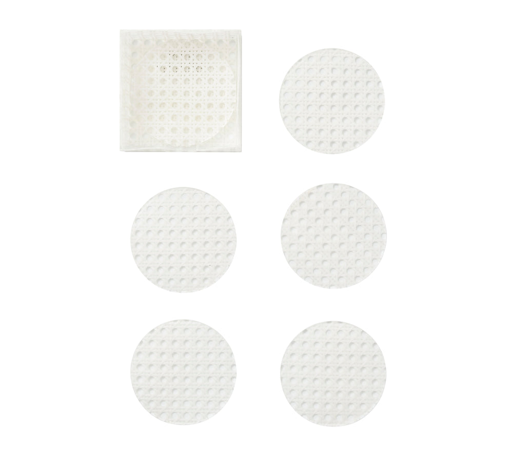 Top view of six white Reed Coasters in an acrylic caddy showcasing woven cane pattern on a white background
