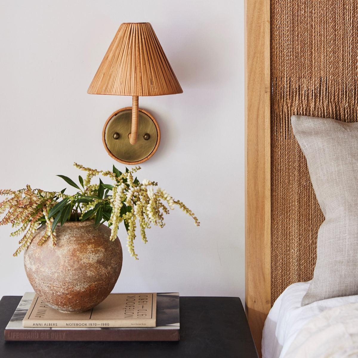 delphine sconce next to bed