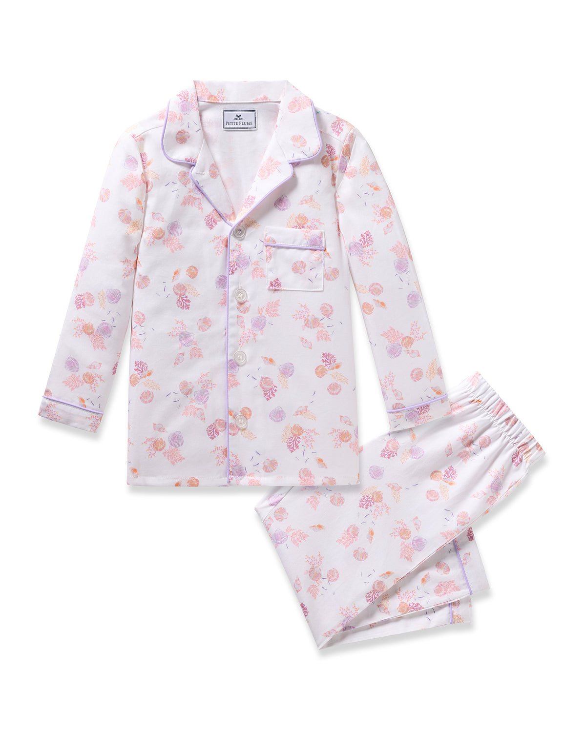 The Petite Plume Kids Twill Pajama in Seashell Splendor features a yarn-dyed cotton floral design with a long-sleeve top and pants. Pastel flowers are accentuated by purple piping on the collar and cuffs, with a front pocket on the top and an elastic waistband on the pants for comfort.