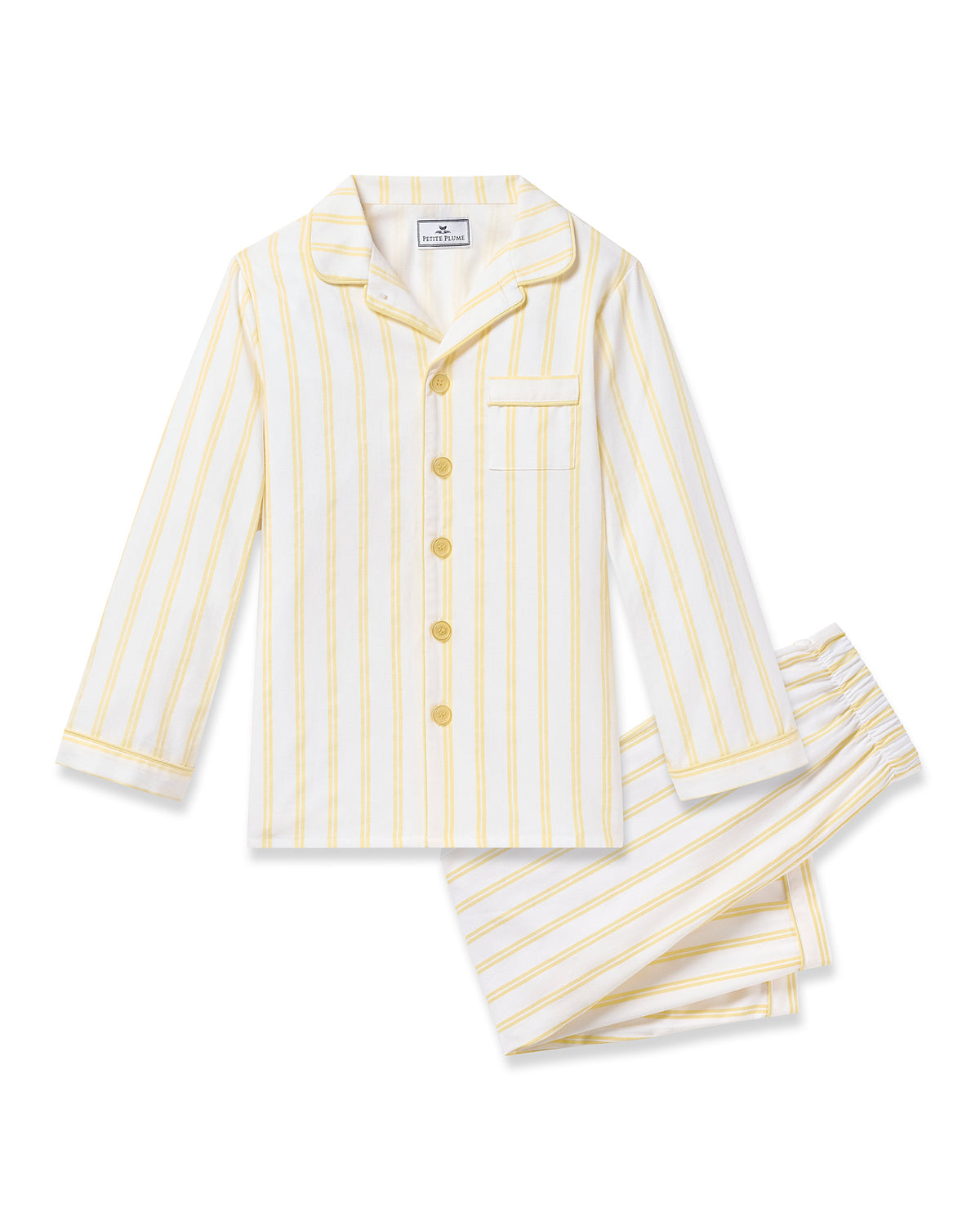 The Kids Twill Pajama in Sunny Stripe by Petite Plume is a yarn-dyed cotton two-piece set with yellow and white stripes. It includes a buttoned long-sleeve top with collar, pocket, yellow buttons, and matching pants with an elastic waistband.