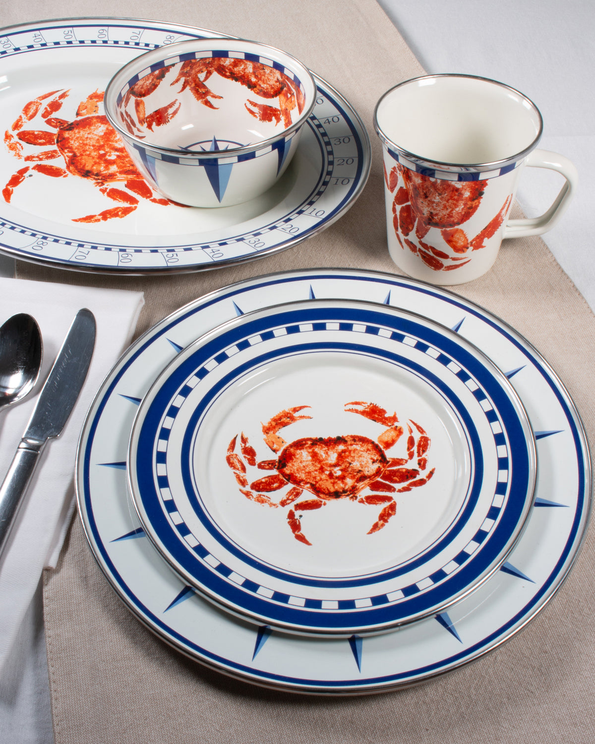 Overhead view of Dinner Plates in Crab House showcasing red crab artwork and blue nautical trim with table setting background