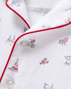 Close-up of Petite Plumes Babys Twill Summer Romper in Coastal Charms prints with bicycles, Adirondack chairs, sailboats, and lobsters. It features brushed twill fabric, red piping on the collar, and clear buttons.