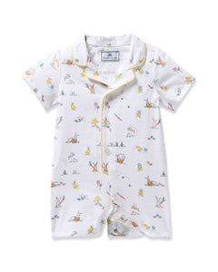 Petite Plumes Babys Twill Romper in Easter Frolic, a white short-sleeve romper, features a delightful print of bunnies, ducks, and nature scenes. With yellow piping on the collar and button placket, its perfect for summer.