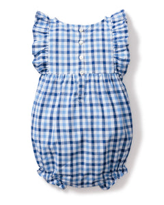 The Petite Plume Babys Twill Ruffled Romper in Royal Blue Gingham features charming ruffled sleeves, a round neckline, and a button-up back with five white buttons for easy dressing. Elastic leg openings provide comfort, and the brushed fabric adds extra softness.