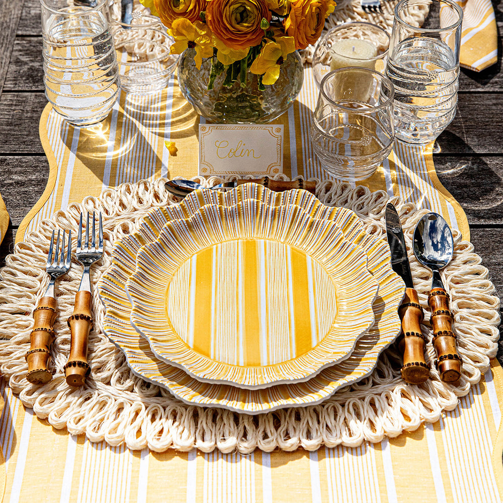 Cabana Stripe melamine dessert plate layered on matching salad plate at outdoor tablescape with striped runner, woven placemat, bamboo-handled flatware