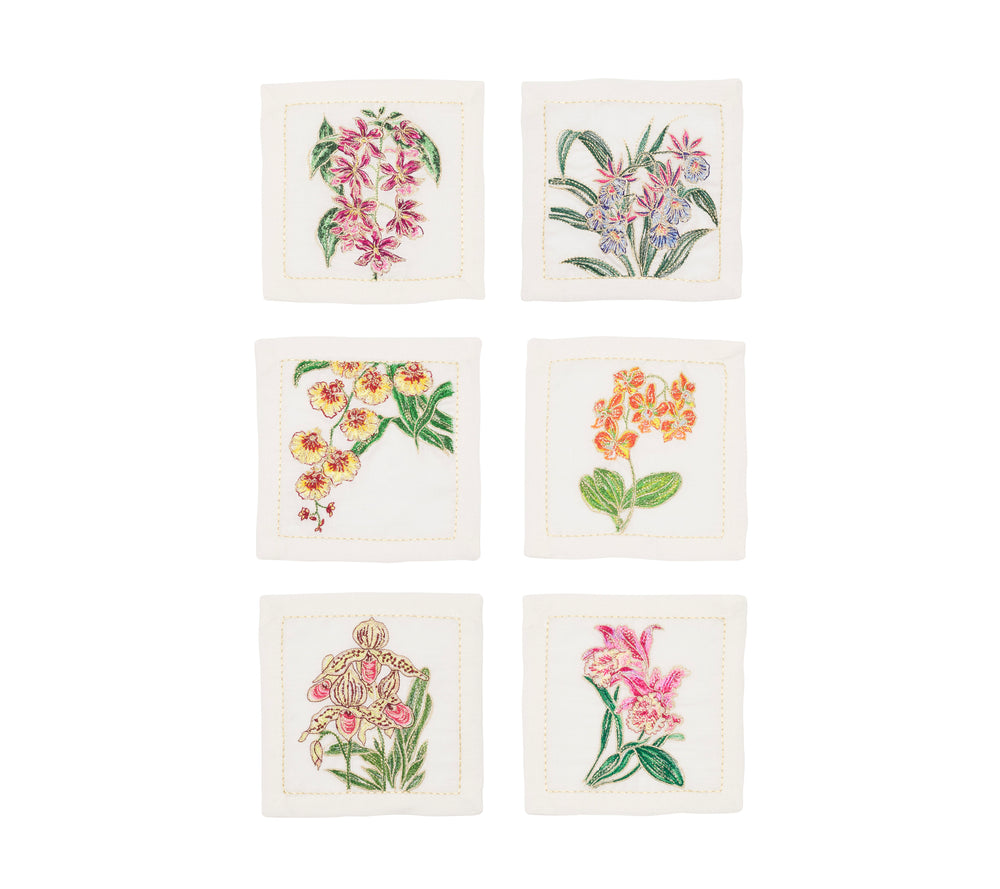 Top down view of set of six Orchid cocktail napkins showcasing hand embroidered multicolored orchid designs on white background