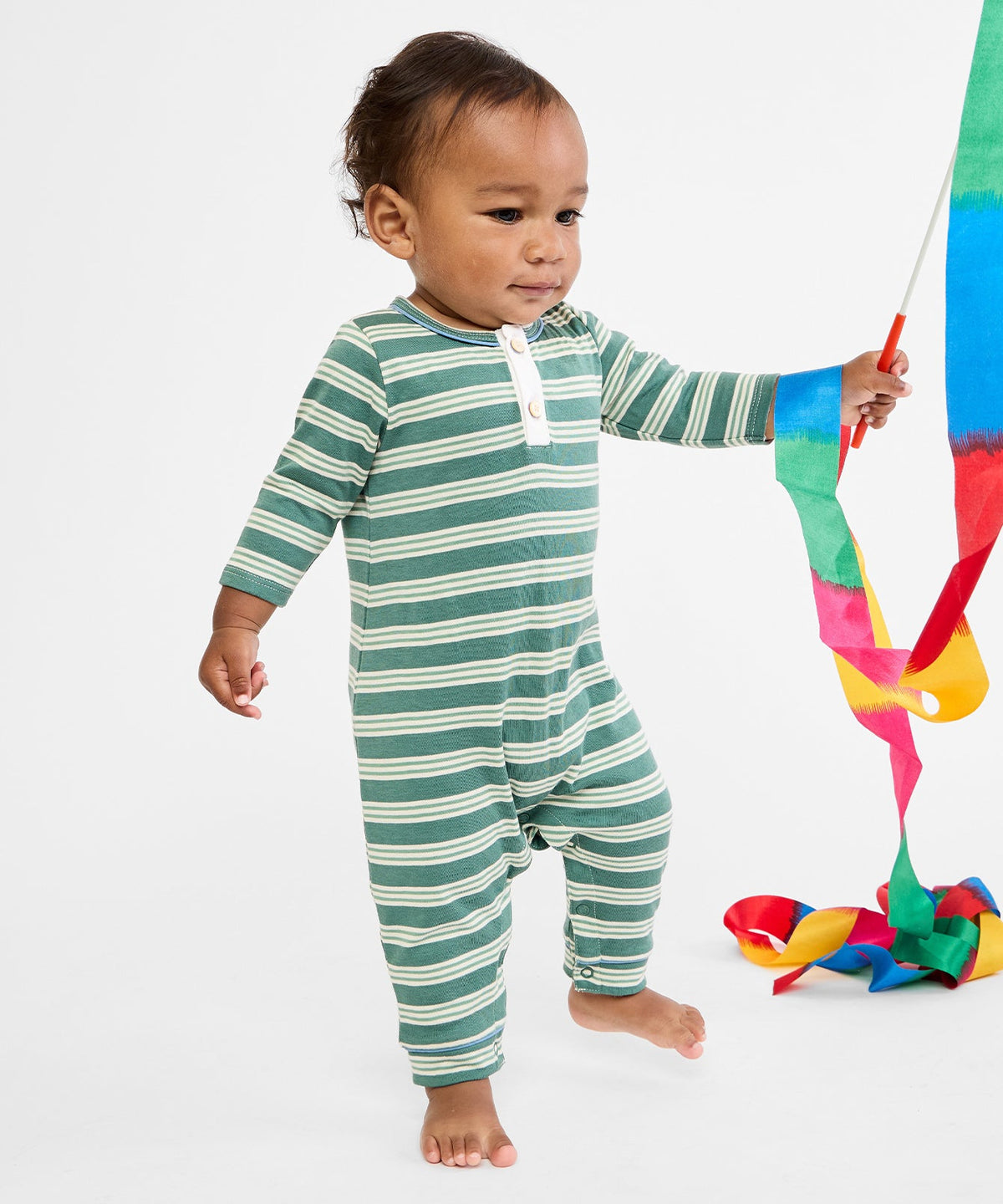 Front view of Campbell Romper in Pine Twin Stripe showing green and cream stripes and front buttons on child